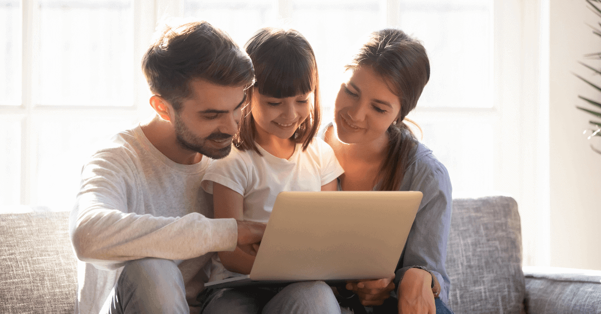 A family of three looking a laptop screen for legal services by MEUS Law